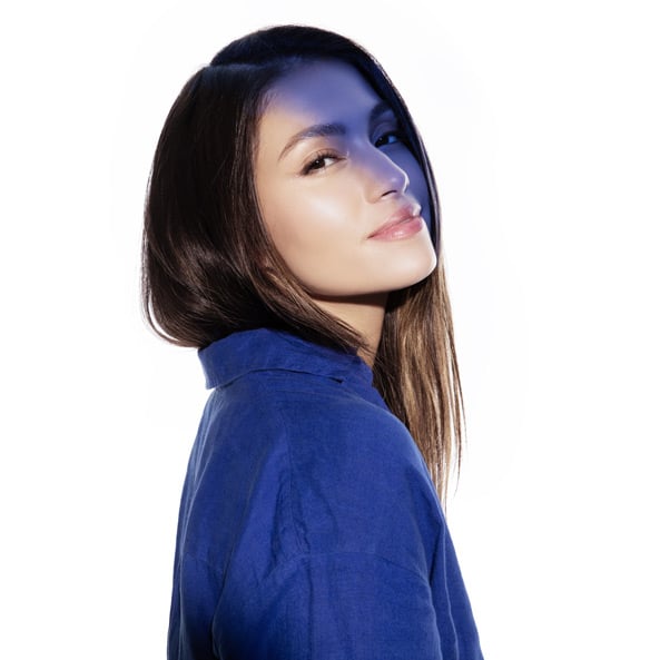 Woman with long hair, blue shirt.