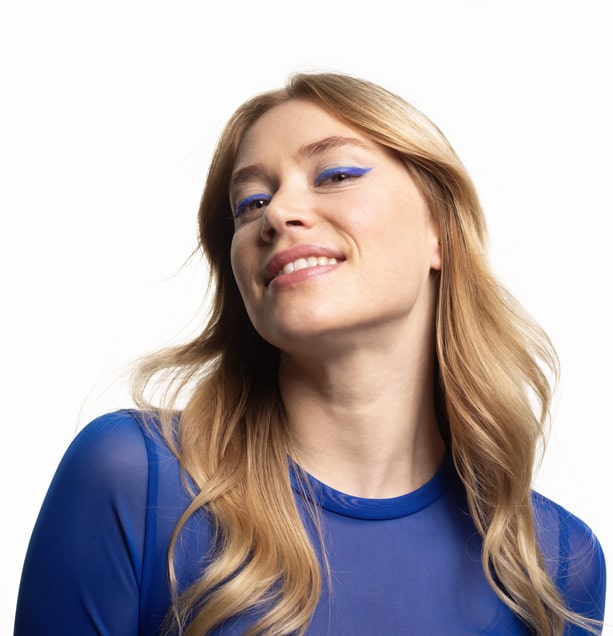 Woman with blue eyeliner and smile